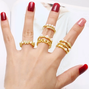 Set of four gold-plated butterfly and star open rings with faux pearls and tiny diamonds