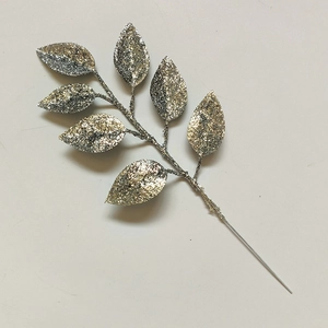 Close-up of artificial silver glitter leaves branch for DIY Christmas tree decoration
