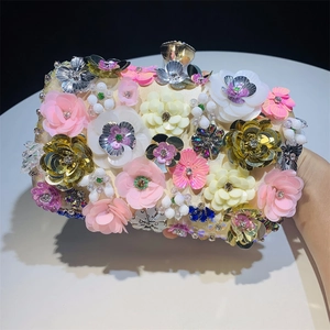 Detailed close-up of handmade floral beaded evening clutch with shimmering 3D flower petals