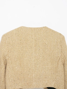 Detail of gold tweed jacket with sequins showing woven texture and back stitching