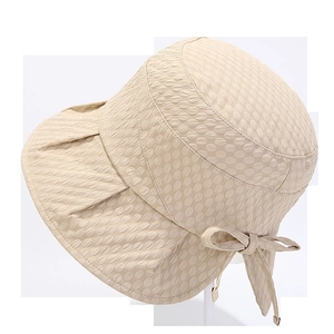 Detail of beige sun hat with bubble texture fabric and stylish side bow decoration