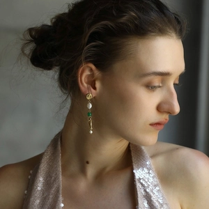Elegant 18K gold plated long tassel earrings with white pearls and green bead on model