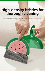 Close-up of mini watermelon broom set with high-density bristles cleaning a table
