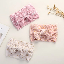Detailed set of three floral ribbed baby headbands with soft bows in pink and cream