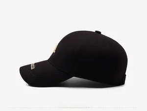 Detailed side view of black cotton baseball cap with intricate gold letter embroidery