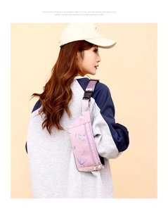 Pink gradient sports fanny pack with adjustable strap worn by a model in a side view
