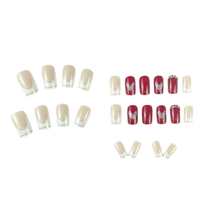 Short French red and cream press-on nails with heart patterns and glitter accents