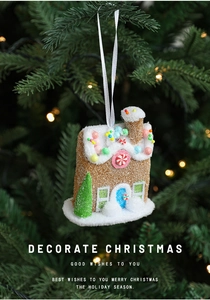 Close-up of pink gingerbread house ornament with colorful beads on Christmas tree branch