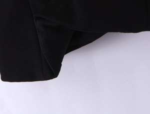 Close-up of the black fabric texture and fine stitching on this tube top with bow