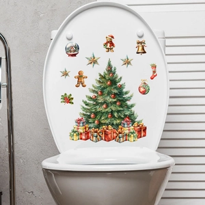 Detail of watercolor Christmas tree and gift box decals applied on a white toilet lid