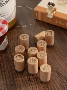 Close-up of beech wood stamps featuring cute bakery and coffee theme carvings