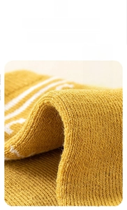 Macro view of thickened terry warm layer on soft ginger yellow winter socks