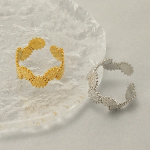 Adjustable geometric stainless steel rings in gold and silver with textured bead pattern