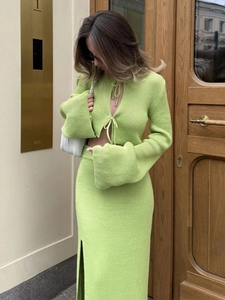 Detail of avocado green ribbed knit two-piece set featuring flared sleeves and tie-up front