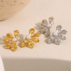 Exaggerated floral stud earrings with white pearls in gold and silver plating