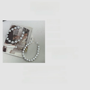 Detail of S925 sterling silver bracelets featuring cat eye beads and silver balls on magazine