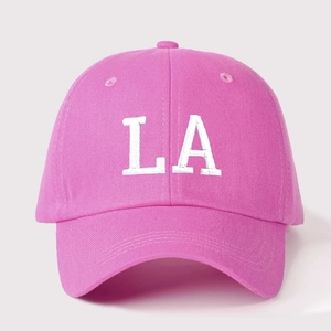Close-up of high-quality white L.A embroidery on a rose pink cotton baseball cap