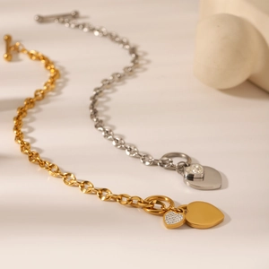 Macro detail of OT toggle heart bracelets in gold and silver with shimmering pavé stones
