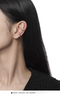 Close-up of gold and silver S925 sterling silver ear cuffs with colored zircon stones