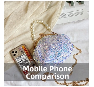 Detail of sequin shell bag with pearl handle and metal chain shown with smartphone