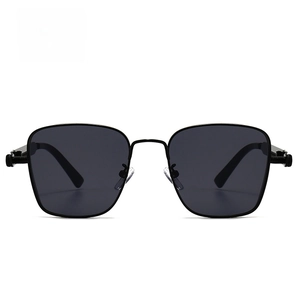 Detailed close-up of vintage square steampunk sunglasses with black metal frame and dark lenses
