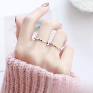 Polished titanium steel rings shown on model finger with a minimalist silver finish