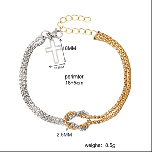 Detail of gold box chain bracelet showing cross pendant dimensions 18mm by 10.5mm