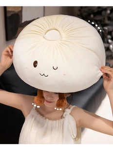 Close-up of soft plush bun pillow with cute embroidered face and brown short legs