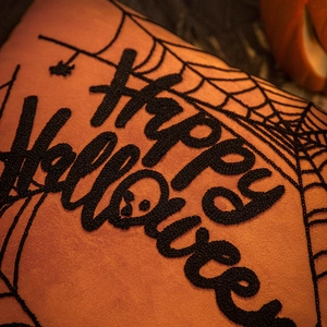 Orange Halloween throw pillow cover with black embroidery spider web and text decoration