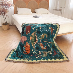 Bohemian dinosaur woven picnic blanket with green jacquard pattern and tassel fringe