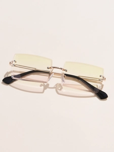 Close-up of rimless square sunglasses with gold metal temples and gradient tint lenses