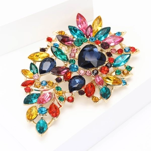 Detailed macro shot of a heart-shaped crystal alloy brooch with multicolor rhinestones