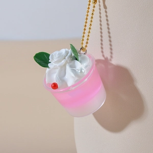 Miniature pink ice cream cup keychain with rose cream topping and gold beaded chain