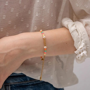 Colorful crystal beads and pearl bracelet with gold adjustable chain on woman wrist