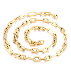 Golden titanium steel paperclip chain necklace in a spiral coil on white backdrop