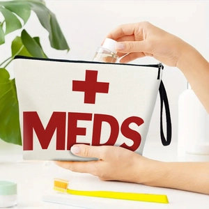 White canvas first aid pouch with MEDS printing and person putting a bottle inside
