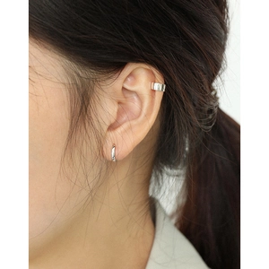 Minimalist S925 sterling silver hoop earrings and smooth ear cuff on a model's ear