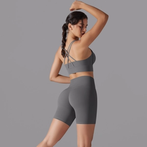 Dettaglio del reggiseno sportivo con incrocio sulla schiena e pantaloncini yoga grigio