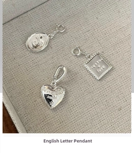 Detailed close-up of S925 silver pendants with embossed Smile, Best wishes and Love motifs