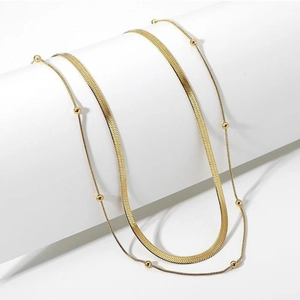 Double-layer gold stainless steel necklace featuring sleek snake and beaded link chains