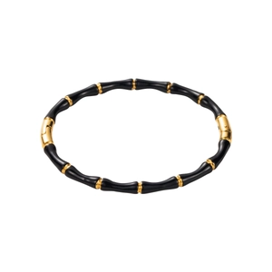 Chic bamboo-shaped stainless steel bangle with black enamel segments and gold accents