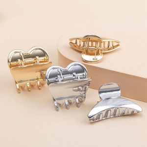 Golden and silver metal hair claws in heart and geometric shapes for high ponytail styling