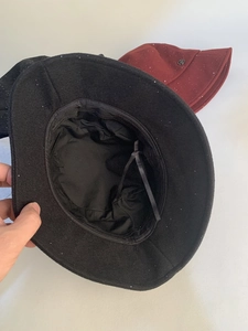 Close-up of wool bucket hat with sequins showing black silk lining and inner ribbon detail