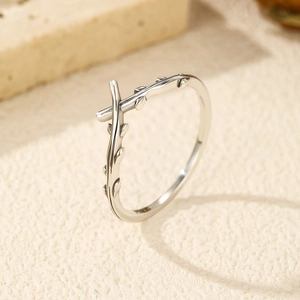 S925 sterling silver vintage olive branch crossover ring on a soft textured stone surface