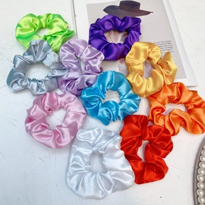 Close-up of colorful glowing LED satin scrunchies in 10 vibrant colors for parties