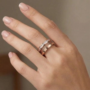 Detail of rose gold multi-layer ring featuring Roman numerals and zircon stones