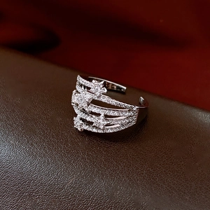 Detailed macro shot of multi-layer silver star ring with micro-pave white cubic zirconia
