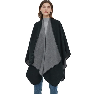 Women's reversible black and gray knit poncho wrap with decorative stitched edges