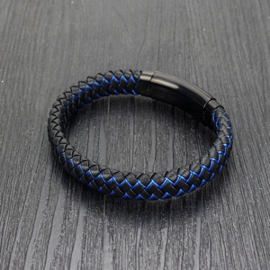 Detail of black braided leather bracelet with blue accents and magnetic metal clasp