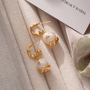Baroque pearl earrings with gold leaf accents on a vintage gold metal hook
